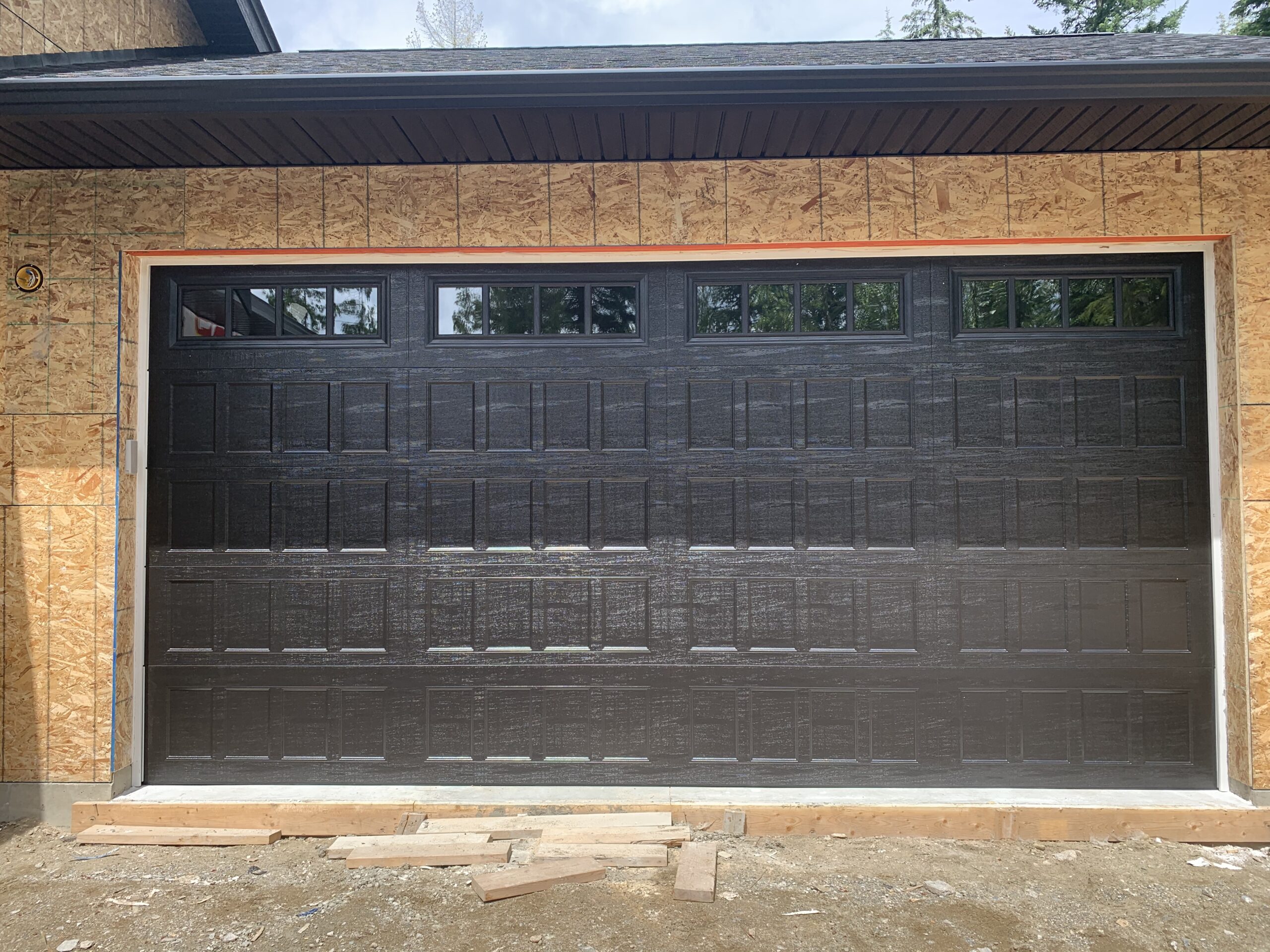 Black modern garage door with windows