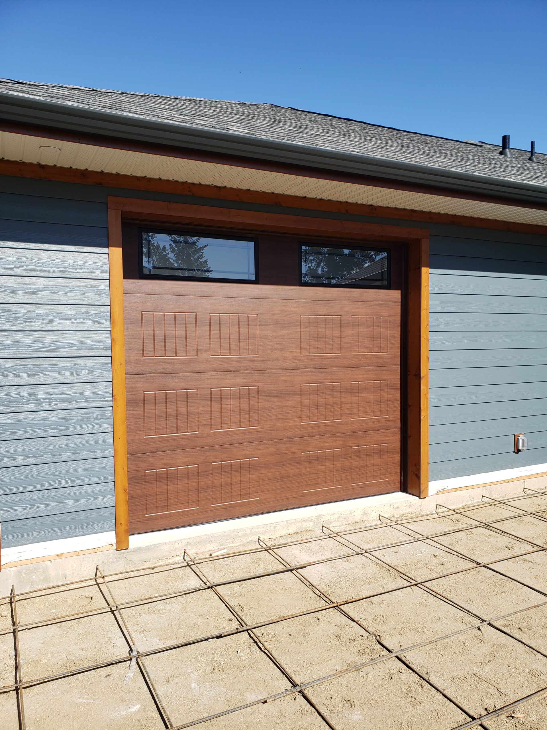 Modern faux wood garage door with 2 windows 