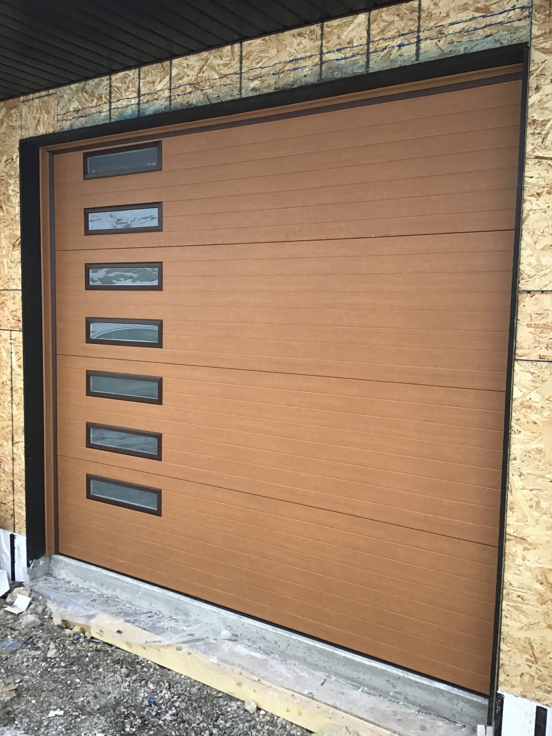 Faux wood garage door with windows on the side