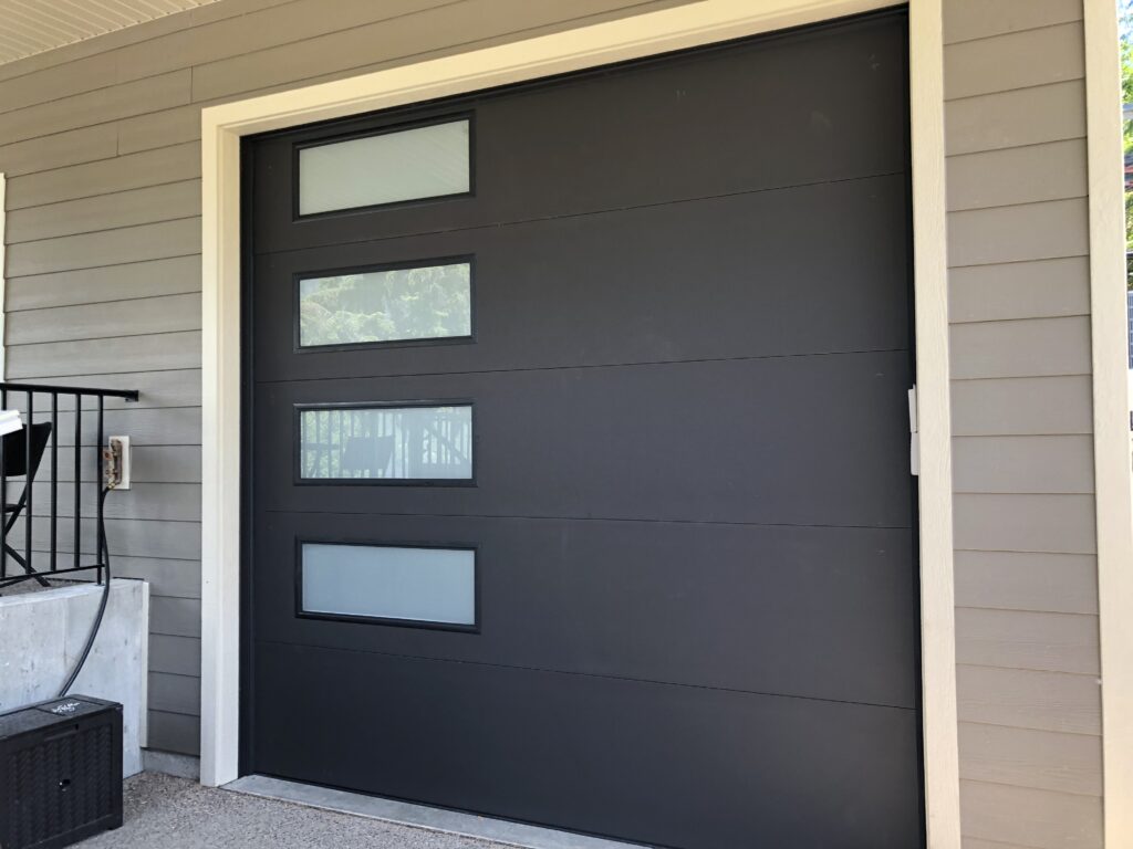 Modern flush panel garage door with windows, garage door installation