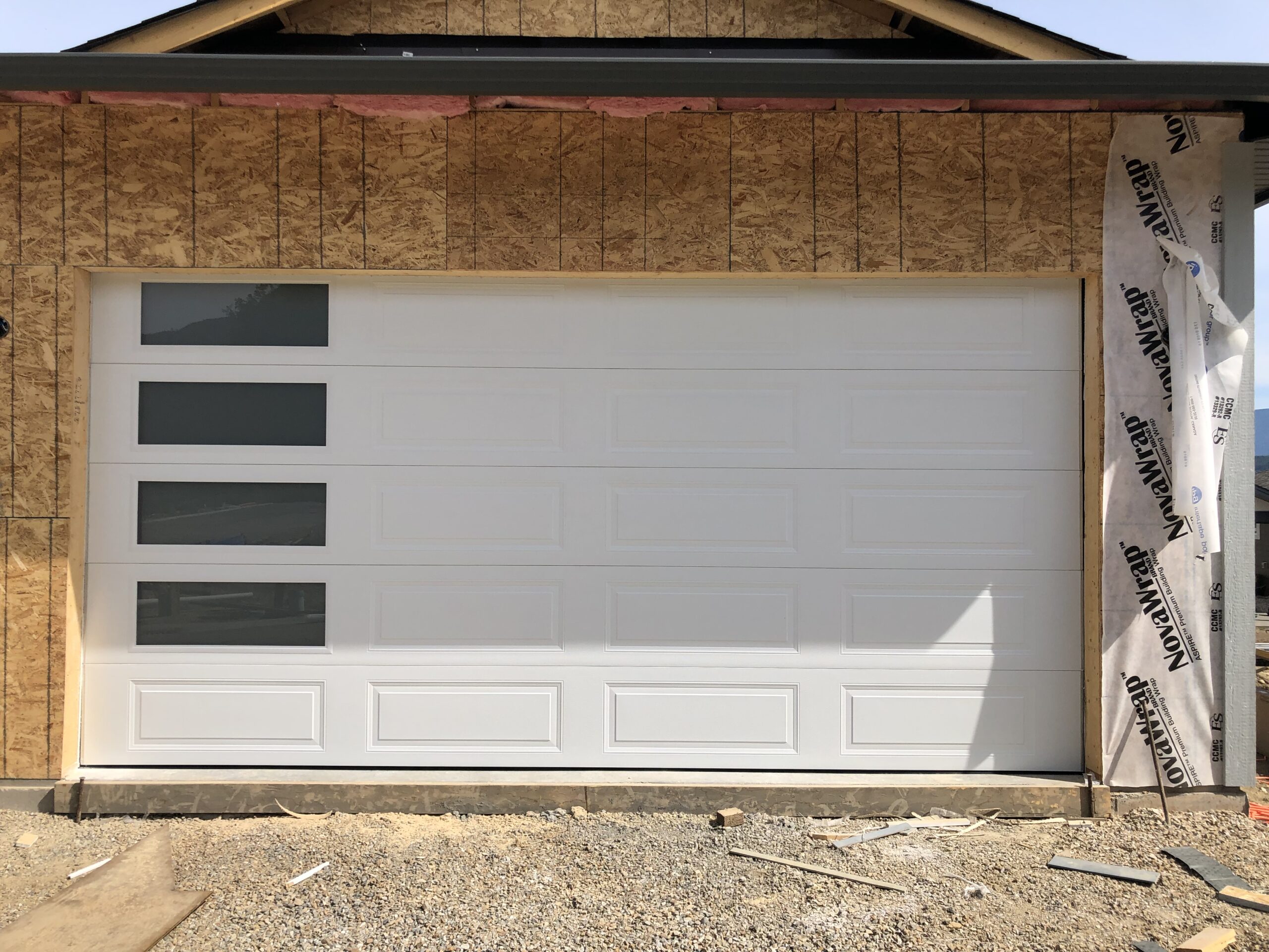 white traditional garage door with windows on the side 