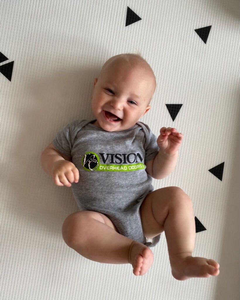 baby wearing Vision Overhead Doors onesie