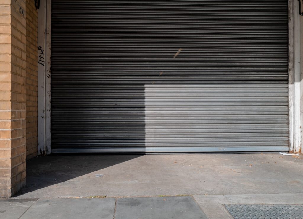 Commercial garage door installation showcasing a metallic roll-up door in a Vernon business setting, emphasizing security and functionality.
