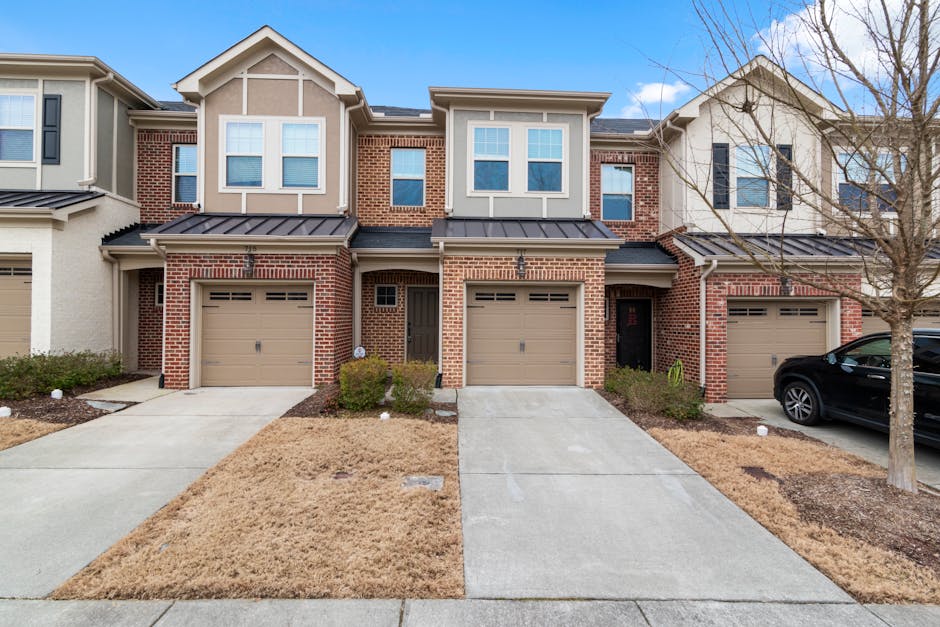 Residential garage doors in Armstrong, BC, featuring various styles and colors, emphasizing curb appeal and home security.