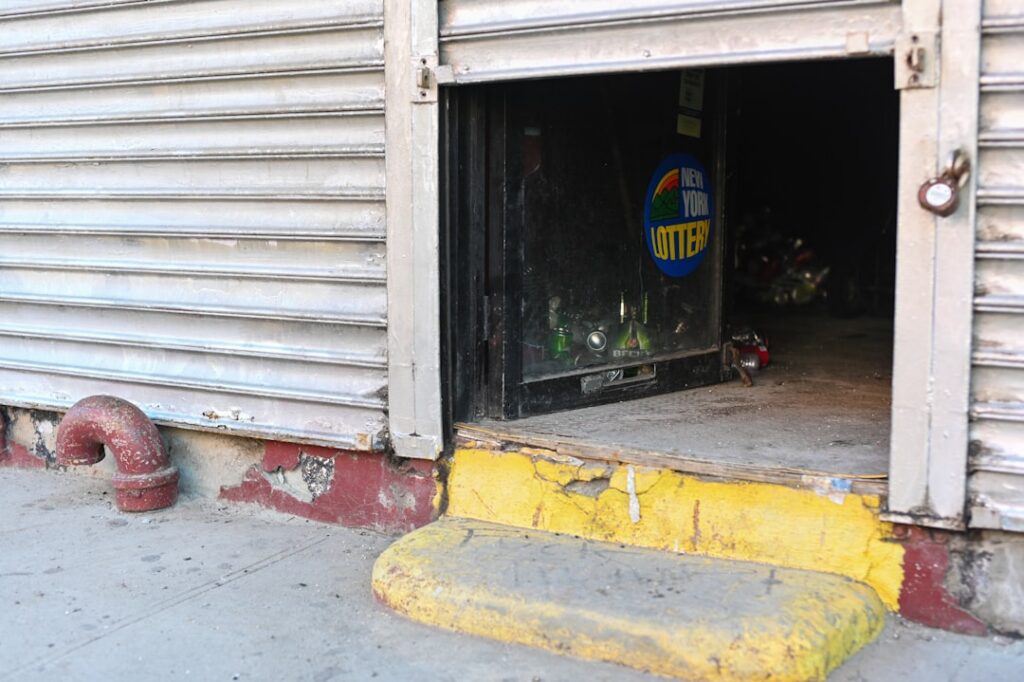 Garage door with broken spring, emphasizing urgent repair needs for same-day service in Salmon Arm by Vision Overhead Doors.