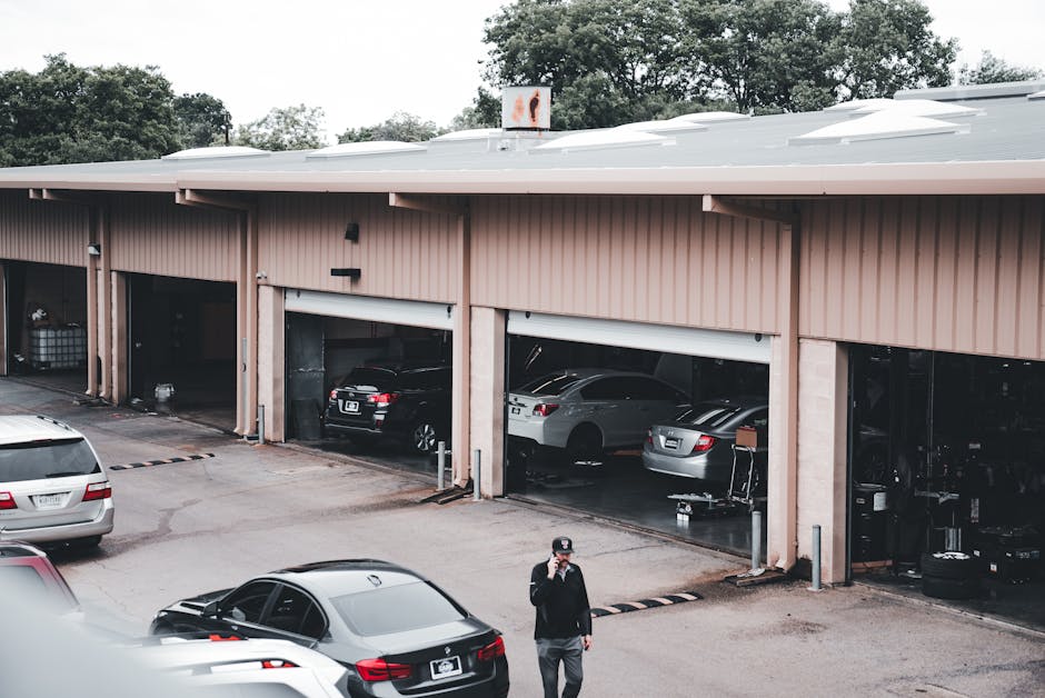 Garage door repair service facility with multiple cars parked outside, emphasizing emergency garage door repair in Sicamous by Vision Overhead Doors.